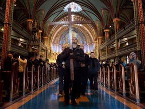 The Way of the Cross procession leaves Notre Dame Basilica on Good Friday in this 2014 file photo.