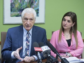Lawyer Guy Bertrand speaks at a news conference where he confirmed, on behalf of Bloc Québécois Leader Martine Ouellet, he served papers to TVA and political commentators of La Joute, over comments they made. His daugher Dominique Bertrand looks on.