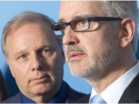 Jean-Martin Aussant, right, a former PQ and founder of Option Nationale announces his return to the Parti Quebecois as leader Jean-Francois Lisee looks on at a news conference Thursday, February 22, 2018 in Montreal.