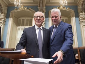 Quebec Finance Minister Carlos Leitao is joined by Quebec Premier Philippe Couillard, right, as he arrives to table his budget, Tuesday, March 27, 2018 at the National Assembly in Quebec City.