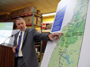 In this Aug. 15, 2015 file photo, Bill Quinlan, president of Eversource Operations in New Hampshire, presents revised plans for the proposed Northern Pass hydroelectric project at Globe Manufacturing in Pittsfield, N.H.