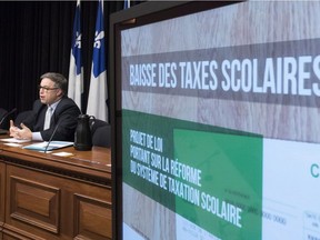 Quebec Education and Family Minister Sébastien Proulx responds to reporters questions after he tabled legislation on school taxation, Thursday, December 7, 2017 at the National Assembly in Quebec City.