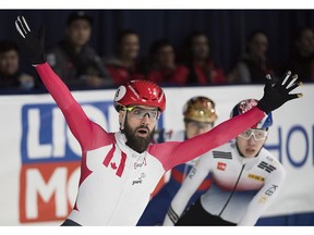 Quebecer Charles Hamelin celebrates after winning the 1,500-metre final race at the ISU world short-track speedskating championships in Montreal on Saturday, March 17, 2018.
