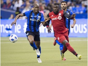 Impact defender Rod Fanni, left, challenges Toronto FC forward Jozy Altidore, during first half MLS action in Montreal on Saturday, March 17, 2018.