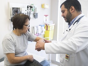 Doctor Juan Gardie Suarez, medical director of the Herzl Clinic, examines patient Mela Asuncion at the Côte-des-Neiges facility. Doctors at the clinic concede that they must still sometimes turn away patients, but a survey of its services "found that 97 per cent of patients would recommend us to their friends and family."