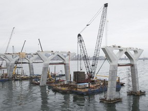 Legs of the new Champlain Bridge are slowly assembled by massive cranes on the river section of the work site on Friday, February 23, 2018.