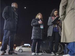 Mardoche Mertilus left, Sylvia Rivaes middle and Marian Naguip right speak with a man during the I Count MTL homeless census, on Dorval Ave. in Dorval on Tuesday, March 24, 2015.