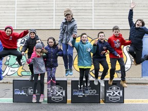 Forest Hill Junior School students jump off boxes that will be used in a community obstacle course fundraiser at the school in St. Lazare.