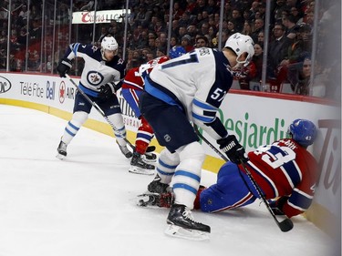 Montreal Canadiens left wing Daniel Carr is boarded by Winnipeg Jets defenceman Tyler Myers during NHL action in Montreal on Tuesday April 3, 2018.