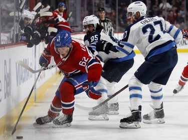 Montreal Canadiens left wing Artturi Lehkonen is under pressure as Winnipeg Jets centre Mathieu Perreault and Winnipeg Jets left wing Nikolaj Ehlers close in during NHL action in Montreal on Tuesday April 3, 2018.