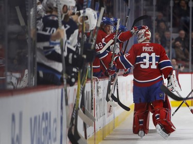 Players celebrate Montreal Canadiens goaltender Carey Price as he sets a new team record of 557 games played during NHL action against the Winnipeg Jets in Montreal on Tuesday April 3, 2018.