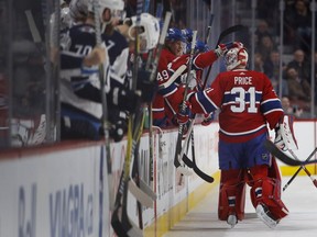 Players celebrate Canadiens goaltender Carey Price Tuesday night at the Bell Centre as he sets a new team record of 557 games played for the Habs.