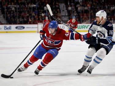 Montreal Canadiens left wing Daniel Carr tries to hold off Winnipeg Jets left wing Shawn Matthias during NHL action in Montreal on Tuesday April 3, 2018.