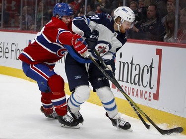Montreal Canadiens defenceman Mike Reilly tries to take the puck from Winnipeg Jets left wing Kyle Connor during NHL action in Montreal on Tuesday April 3, 2018.