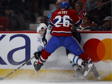 Canadiens defenceman Jeff Petry crunches Jets centre Marko Dano  during action Tuesday night at the Bell Centre.