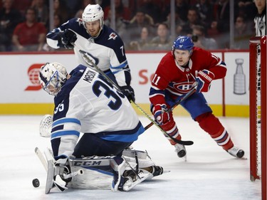 Winnipeg Jets goaltender Steve Mason gets his blocker on the puck as Winnipeg Jets defenceman Ben Chiarot and Montreal Canadiens right wing Brendan Gallagher look for a rebound during NHL action in Montreal on Tuesday April 3, 2018.