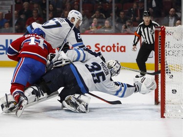 Montreal Canadiens right wing Brendan Gallagher falls over Winnipeg Jets goaltender Steve Mason as Winnipeg Jets defenceman Tyler Myers watches the puck enter the net during NHL action in Montreal on Tuesday April 3, 2018.