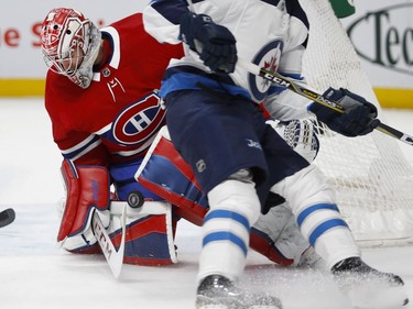Montreal Canadiens goaltender Carey Price makes a save against Winnipeg Jets defenceman Sami Niku during NHL action in Montreal on Tuesday April 3, 2018.