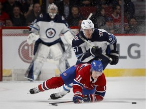 Montreal Canadiens' Brendan Gallagher is knocked to the ice by Winnipeg Jets defenceman Tyler Myers in Montreal on April 3, 2018.