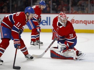 Montreal Canadiens goaltender Carey Price, Montreal Canadiens right wing Brendan Gallagher and Montreal Canadiens defenceman Noah Juulsen look into the net as the Winnipeg Jets score in overtime during NHL action in Montreal on Tuesday April 3, 2018.