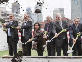 Jean-Marc Arbaud, Henri Poupart-Lafarge, Valerie Plante, Marc Garneau, Philippe Couillard and Michael Sabia at sod-turning ceremony in Griffintown to inaugurate the REM on Thursday April 12, 2018.