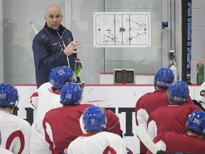 Laval Rocket head coach Sylvain Lefebvre talks with his players during practice in Laval on Thursday.