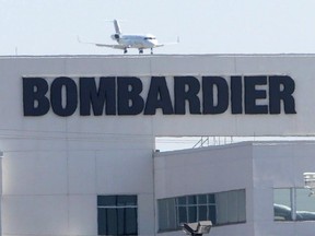 A plane comes in for a landing at a Bombardier plant in Montreal, Thursday, May 14, 2015.