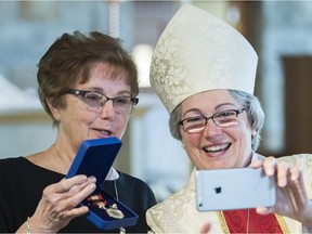 Kirkland's Lorna Fisher presented with Sovereign's Medal for Volunteer by Mary Irwin Gibson, the Anglican Bishop of Montreal.