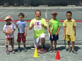 Philippe Manning, pictured here with tennis participants, is a co-founder of the Proset Autism adaptive sports program that seeks to mitigate the hardships and distress associated with autism.