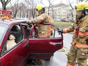 Montreal firefighters perform a simulation of an extraction of an accident victim from a car during the Injury Prevention Fair at Dawson College in Montreal Thursday April 26, 2018.
