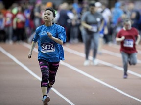 A competitor looks up to a cheering crowd during a 50 metre dash at the Defi Sportif AlterGo in Montreal on Thursday April 26, 2018.