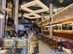 Ibérica’s impressive dining room is distinguished by cathedral ceilings, distressed painted walls and huge chandeliers.