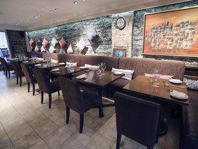 The dining room at Tangia restaurant in Montreal: refreshed decor features lanterns brought in from Morocco and kilim pillows decorating the walls and lining the banquette across from the bar.