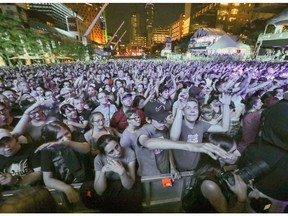 JULY 4, 2017 -- Walk Off the Earth fans are bathed in blue light during outdoor blowout concert during the Montreal International Jazz Festival.