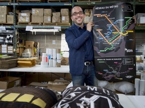 Luigi Vendittelli President of Motivo promotions group in Ville St-Laurent holds a copy of map of the Montreal metro system to be sold at the STM Boutique