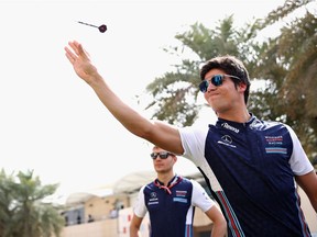 Montreal native Lance Stroll plays darts in the paddock ahead of the Bahrain Grand Prix. Hopes that the Williams team might have taken a step forward over winter testing have proved to be wide of the target.