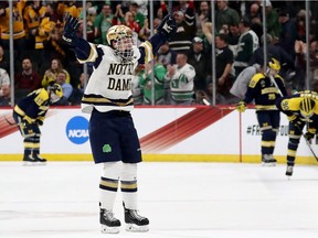 Jake Evans of the Notre Dame Fighting Irish celebrates his game winning goal in the final seconds of the game against the Michigan Wolverines during the semifinals of the NCAA Hockey Championship on April 5, 2018, in St Paul, Minnesota.