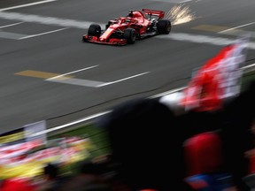 SHANGHAI, CHINA - APRIL 14: Sparks fly behind Sebastian Vettel of Germany driving the (5) Scuderia Ferrari SF71H on track during qualifying for the Formula One Grand Prix of China at Shanghai International Circuit on April 14, 2018 in Shanghai, China.
