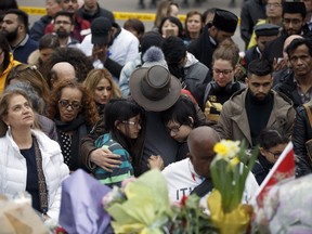 People gather at a memorial for victims of the mass killing on Yonge Street at Finch Avenue on April 24, 2018 in Toronto.