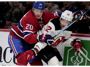 MONTREAL, QUE.: APRIL 1, 2018-- Montreal Canadiens left wing Nicolas Deslauriers grimaces as he drives New Jersey Devils defenseman Ben Lovejoy in to the boards during NHL action in Montreal on Sunday April 1, 2018. (Allen McInnis / MONTREAL GAZETTE) ORG XMIT: 60