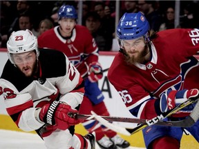 New Jersey Devils' Stefan Noesen and Canadiens defenceman Brett Lernout get their sticks crossed up in Montreal on Sunday, April 1, 2018.