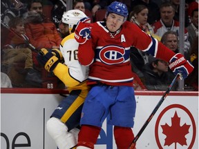 Canadiens' Brendan Gallagher delivers a hard check and drives Nashville Predators defenceman P.K. Subban into the boards in Montreal on Feb. 10, 2018.