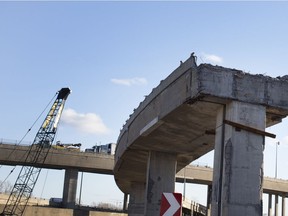 Traffic heads south towards the Champlain Bridge ramps as a partial demolished section of the old Turcot Interchange remains awaits full demolition as part of the rebuilding project in Montreal on Thursday April 5, 2018.