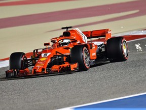 Ferrari's German driver Sebastian Vettel drives his car in the qualifying session to win pole position on April 7, 2018, ahead of the Bahrain Formula One Grand Prix at the Bahrain International Circuit in Sakhir.