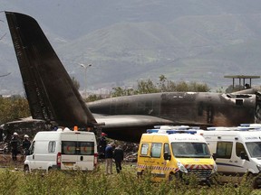 Firefighters and civil security officers work at the scene of a fatal military plane crash in Boufarik, near the Algerian capital, Algiers, April 11, 2018.