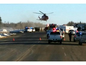 This image provided by 650 CKOM/980 CJME shows emergency crews responding to the scene where a bus carrying a junior hockey team to a playoff game was struck by a semi Friday, April 6, 2018, north of Tisdale, Saskatchewan, Canada.   Police say there were 28 people, including the driver, on board the bus of the Humboldt Broncos team when the crash occurred around 5 p.m. Friday on Highway 35.   (650 CKOM/980 CJME via AP)