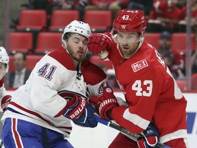 Red Wings winger Darren Helm checks Canadiens winger Paul Byron, left, during the first period Thursday night in Detroit.