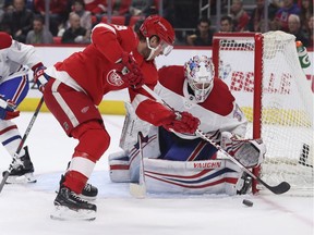 Detroit Red Wings left wing Justin Abdelkader (8) tries shooting the puck past Montreal Canadiens goaltender Antti Niemi (37) during the second period of an NHL hockey game Thursday, April 5, 2018, in Detroit.