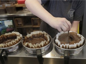 Ashlee Jones prepares coffee at a Philz Coffee shop in San Francisco, Friday, March 30, 2018. Coffee sellers will have to post ominous warnings in California because each cup contains a chemical linked to cancer, a judge ruled. The culprit is a byproduct of the bean roasting process that is a known carcinogen and has been at the heart of an eight-year legal struggle between a tiny nonprofit group and big coffee companies.