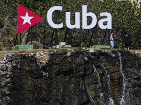 Tourists walk in the gardens beside the waterfall of the Nacional Hotel in Havana, Cuba, Wednesday, April 18, 2018.